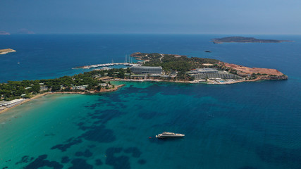 Aerial drone bird's eye panoramic photo of famous celebrity sandy beach of Astir or Asteras in south Athens riviera with turquoise clear waters, Vouliagmeni, Greece
