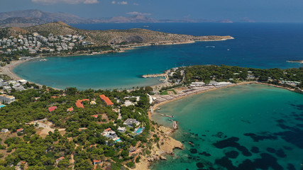 Naklejka na ściany i meble Aerial drone bird's eye panoramic photo of famous celebrity sandy beach of Astir or Asteras in south Athens riviera with turquoise clear waters, Vouliagmeni, Greece