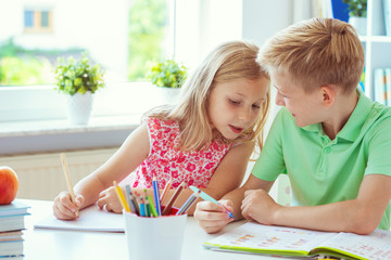 Schoolchildren are came back to school and learning at the table in classroom