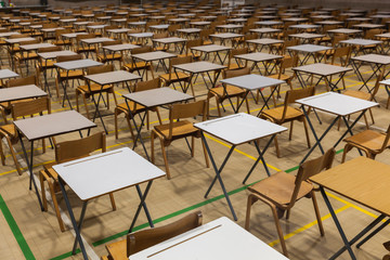 Exam tables set up in a sports hall for exams in a high school & sixth form
