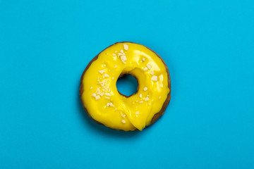 donut with yellow icing on a blue background