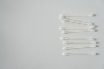 Q-tip, or cotton bud swab top view on white background with horizontal blank empty space for copy...