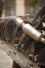 Dirty parts of a truck close up. Springs, engine elements, exhaust pipe and suspension on an off-road vehicle.