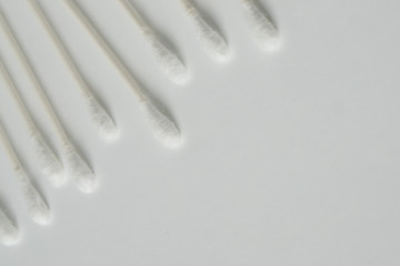 Q-tip, or cotton bud swab top view on white background with horizontal blank empty space for copy or text; Features best health care hygiene practices to clean ear.