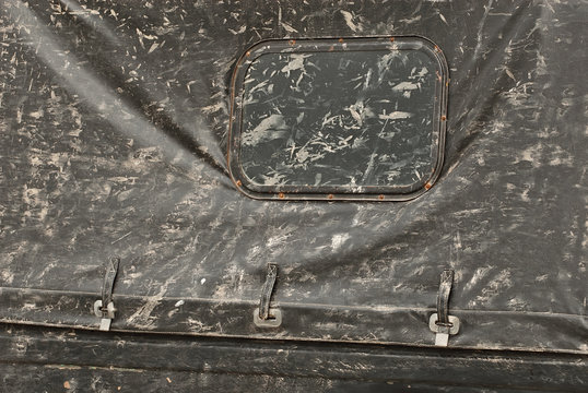 Dirt on the door of an old car. The texture of dirt and dust on a metal close-up. Drops and splashes on a black background.