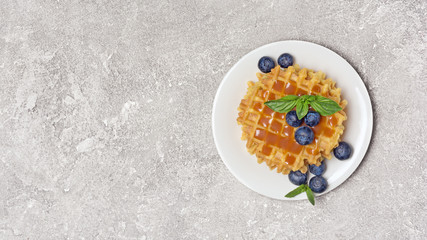 Belgian waffles with fresh berries and caramel sauce