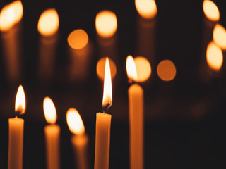 Image of many burning candles with shallow depth of field