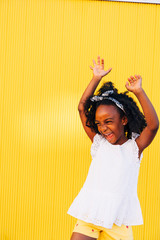 Cute mixed race girl having fun at street. Child innocence concept.