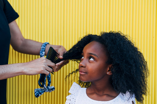 Mother Doing Daughter's Afro Hair