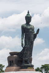 Obraz premium Large Bronze statue Walking Buddha Thailand South East Asia Travel Concept.