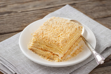 Layered cake with cream Napoleon millefeuille vanilla slice on a white plate.