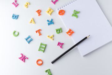 Notepad with pencils on white table