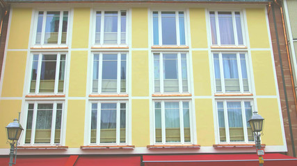 yellow colorful building facade with windows. modern german european architecture style.