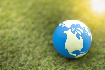 Fototapeta na wymiar Close up of mini world ball on grass lawn.