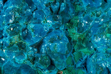 Macro of a mineral stone Chrysocolla Malachite on a white background