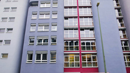 violet colorful building facade with windows. modern german european architecture style.
