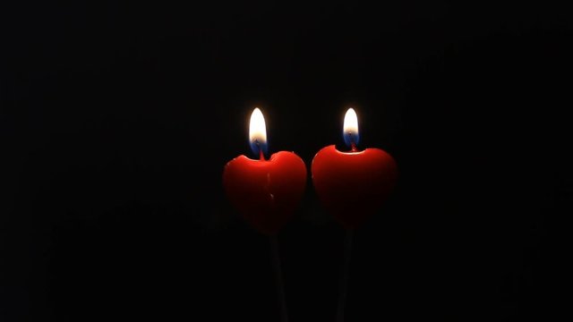 Couple of two red candles lightning in black dark, romantic eternal love, conceptual