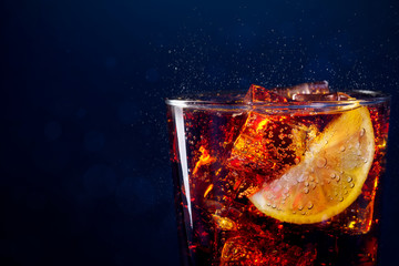 Close up to glass with drink and sliced citrus ice cubes. Close up to clear glass of fresh and...