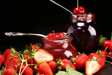 assortment of jams, seasonal berries, mint and fruits. marmalade or confiture