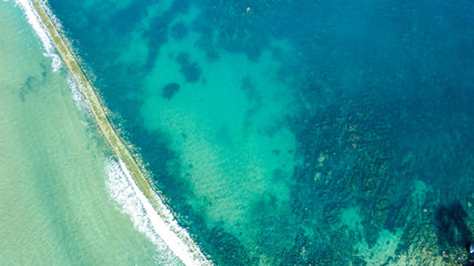 aerial view of path crossing the sea