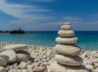Stones balanced on beach.