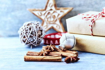 Christmas star, bauble and Christmas presents. Wooden background. 