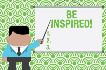 Text sign showing Be Inspired. Business photo text fill someone with urge or ability to do or feel something Businessman standing in front projector screen pointing project idea