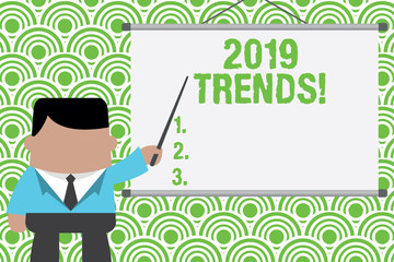 Text sign showing 2019 Trends. Business photo text general direction in which something is developing or changing Businessman standing in front projector screen pointing project idea