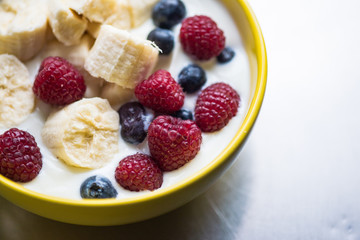 Morning breakfast set with bowl of fruits apples and blueberry.