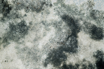 The old cement floor has many stains.