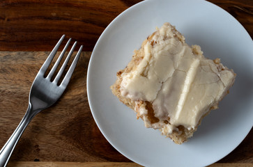 Serving of banana bread with icing on a plate