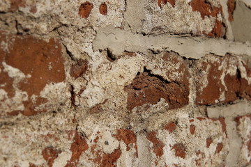 Close up of old wall with ancient crumbling brickwork, structure of bricks abstract background with place for text.