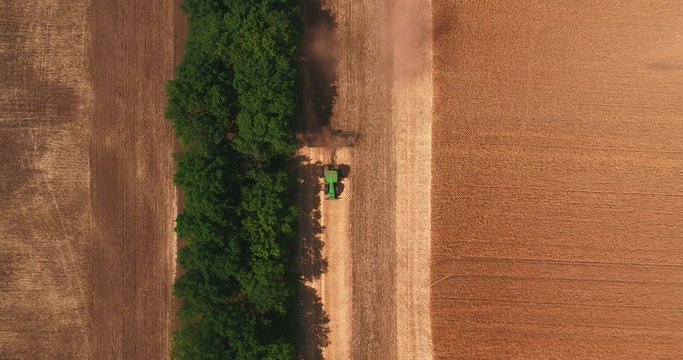 Top view of the tractor ploughing up the field after gathering in wheat 2