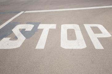  White stop sign on the asphalt