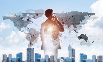 Concept of business success and control with confident boss against cityscape background