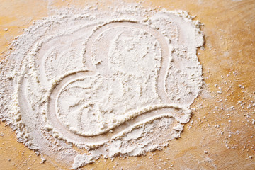 Close-up of heart drawn on flour, love in cooking