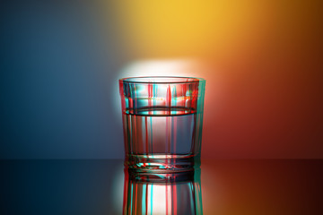 One glass Cup on a colored background, anaglyph, glitch effect, pop art