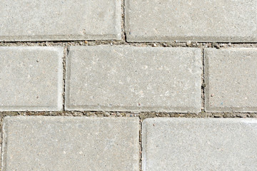 Fototapeta premium Gray paving slabs texture close up. Paving slabs background