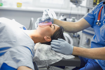 Several doctors surrounding patient on operation table during t