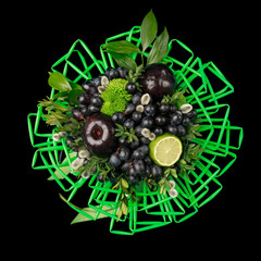 Unique gift handmade in the form of bouquet of flowers and fruits decorated with many green straws for drinks on a black background. Top view