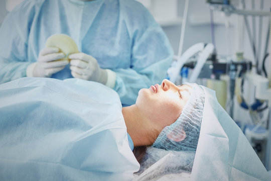 Several Doctors Surrounding Patient On Operation Table During T