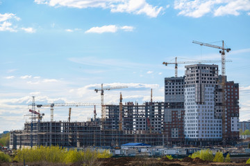 image of a tower cranes at the construction site of a residential house