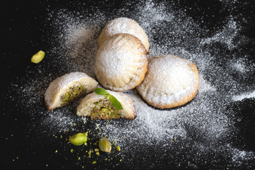 Maamoul - arabic homemade cookies filled with dates and pistachios. Close up.