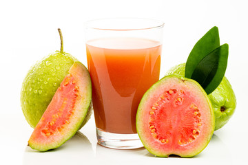 Guava juice and peeled fruit on white background.