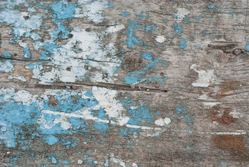 Grunge background. Peeling paint on an old wooden surface. Old scratched painted wood surface