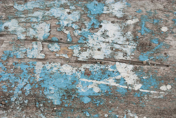 Grunge background. Peeling paint on an old wooden surface. Old scratched painted wood surface