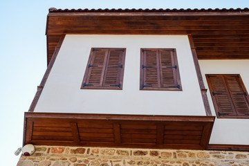 Ancient house with wooden shutters on the windows. City Kaleici in Turkey.