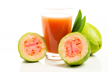 Guava juice and peeled fruit on white background.