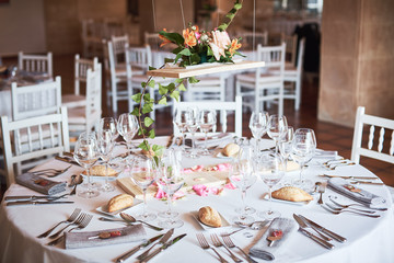 Beautifully decorated tables for guests with decorations in a restaurant.
