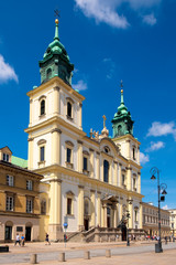 Fototapeta na wymiar Warsaw, Poland - Front view of the baroque Holy Cross Church, at the Krakowskie Przedmiescie street in the Old Town quarter of Warsaw